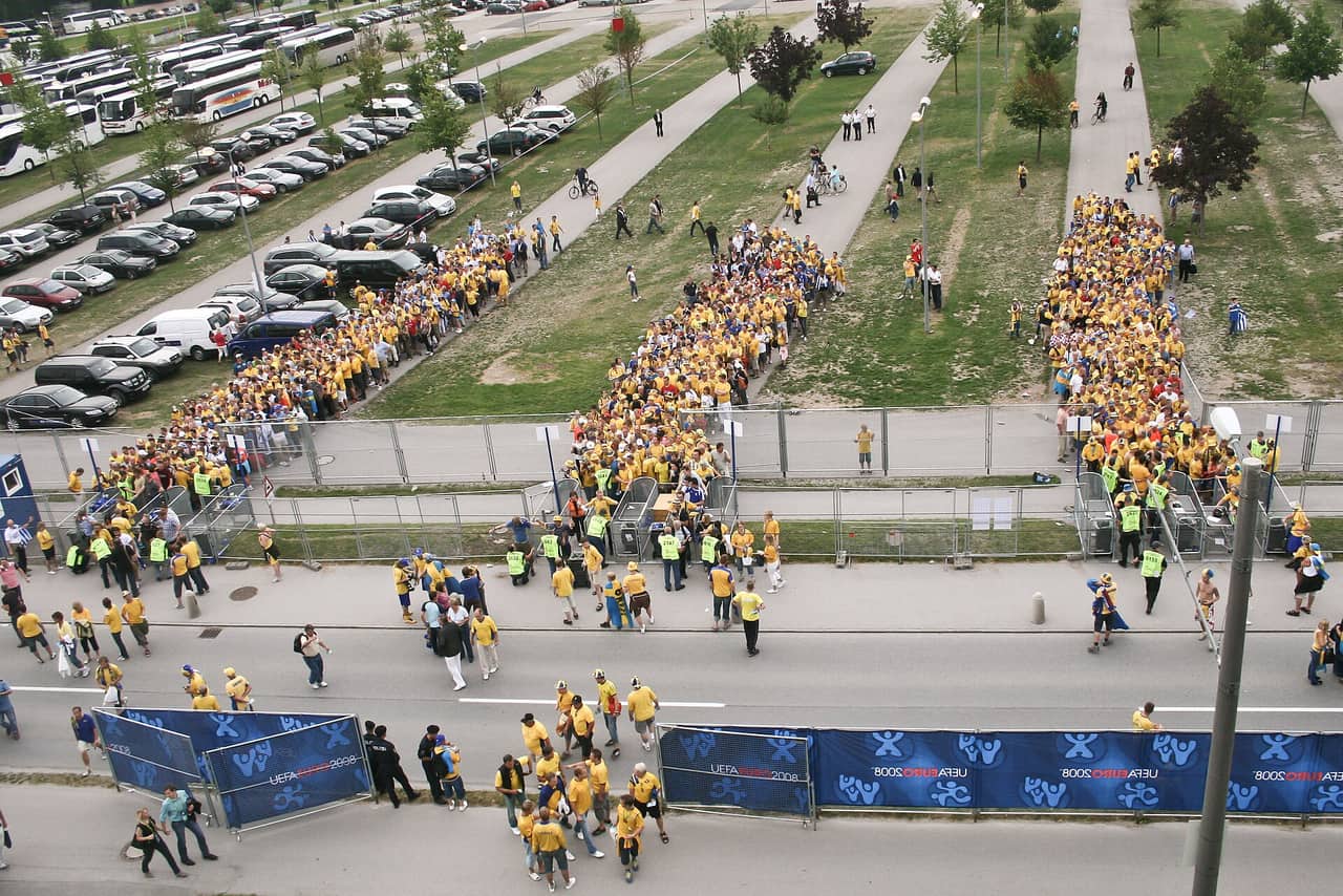 Football fans waiting at the stadium entrance before a major tournament match, matching a FIFA tickets guide for World Cup 2026.
