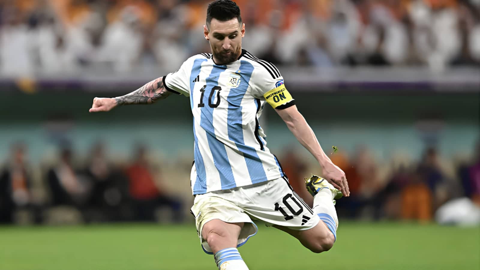 Lionel Messi in Argentina number 10 shirt striking the ball during a World Cup match.