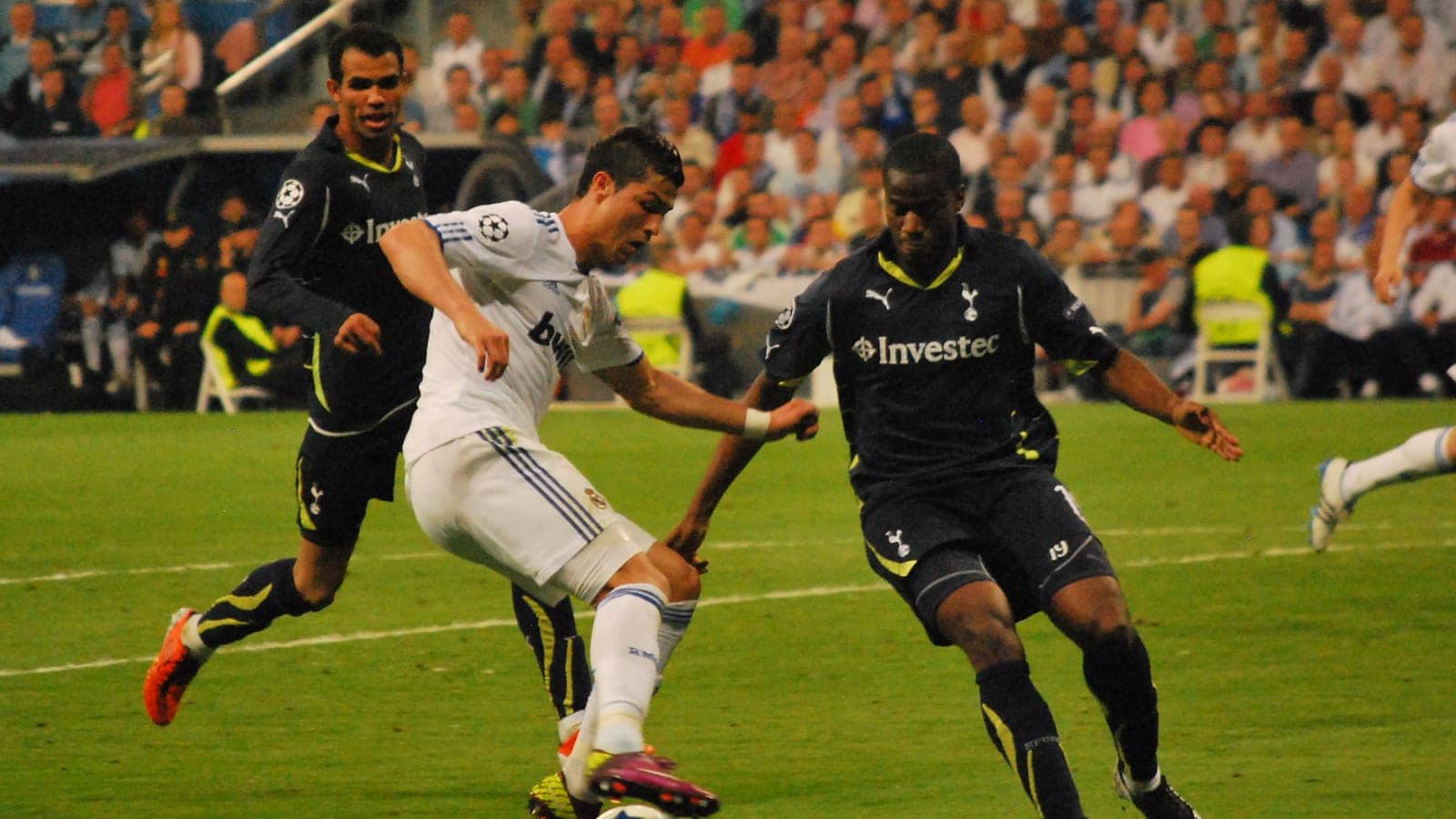 Cristiano Ronaldo dribbles on a football pitch during a European match.