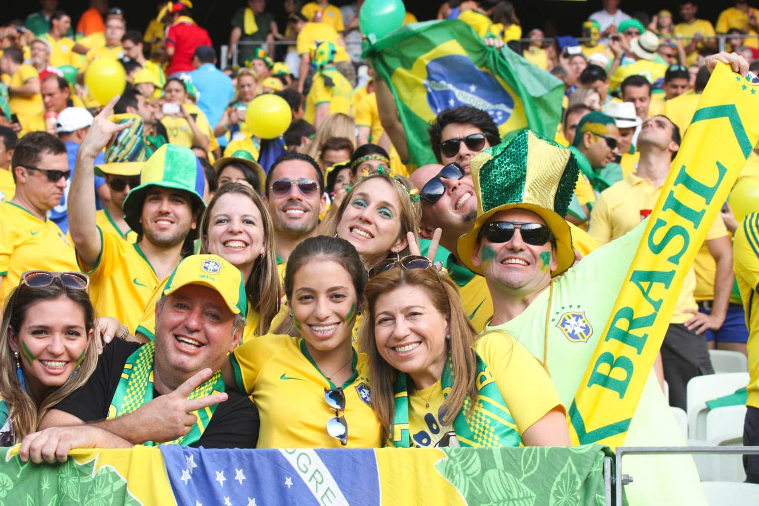 Brazil football supporters in yellow and green at a World Cup match.