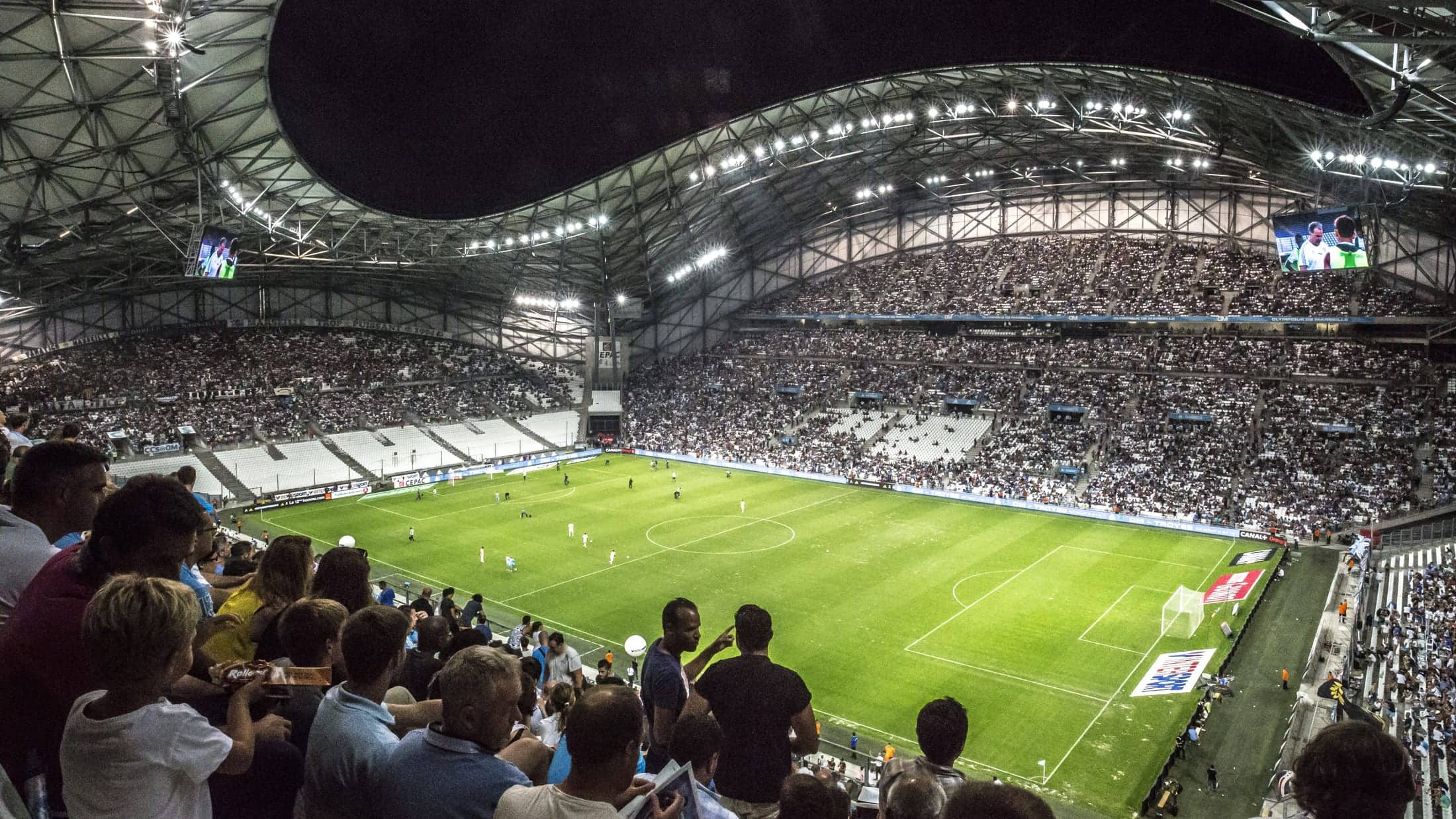 Packed football stadium under the lights, used for a World Cup 2026 Round of 16 confirmed teams tracker.